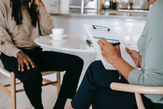 two people sitting at table for tenant interview