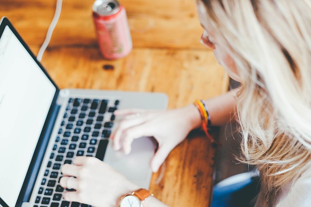 person sitting at desk on computer